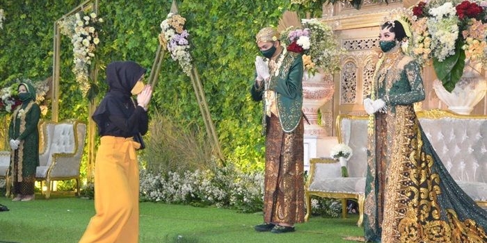 JAGA JARAK: Undangan tidak bersalaman dengan mempelai saat simulasi resepsi pernikahan era new normal, Minggu (12/7). foto: ist.