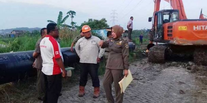 Petugas tengah menghentikan proyek pemasangan pipa gas milik Pertamina Gas di PT. WIKA. foto: SYUHUD/ BANGSAONLINE