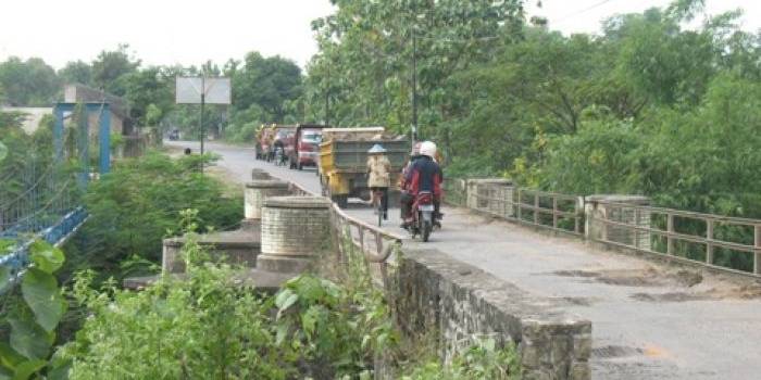 Jembatan Jungke memang tampak sempit. Mobil yang berpapasan di jembatan tersebut terpaksa harus bergantian melewatinya karena lebar jembatan yang hanya sebadan mobil saja. foto: Nanang/BangsaOnline.com