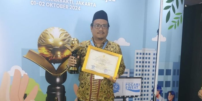 Kepala MAN 1 Tuban, Ahmad Hudan saat menerima penghargaan di acara Festival Adiwiyata Nawasena 2024