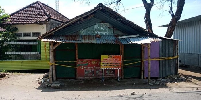 Tempat kejadian perkara warung milik korban yang dipasang garis polisi. foto: AAN AMRULLOH/ BANGSAONLINE