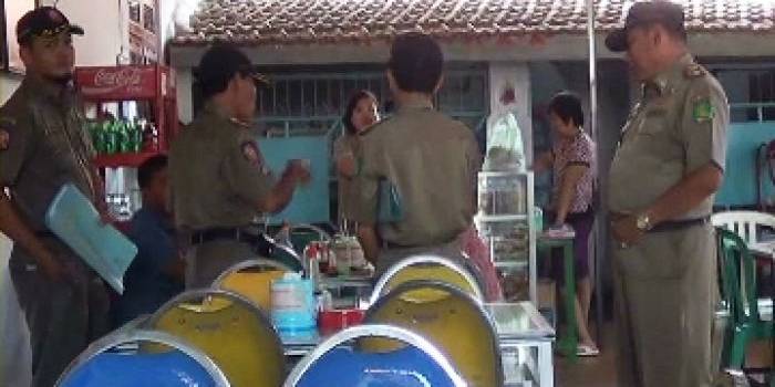 TERTANGKAP BASAH - Saah satu Abdi Negara kepergok petugas satpol PP saat melakukan razia di salah satu warung makan di seputar kota Sumenep saat jam kerja. (foto: faisal/BANGSAONLINE)