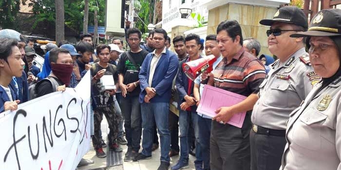 Nur Qolib (memegang toa) saat menemui pendemo. foto: SYUHUD/ BANGSAONLINE