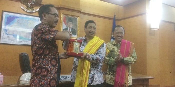 Asisten Pemerintah Kab. Bangkalan Ismed Efendi memberikan cinderamata kepada Bakar Jeriman perwakilan dari DPRD Sumba didampingi Punguh, Asisten Ekonomi dan Pembangunan Setdakab Bangkalan.