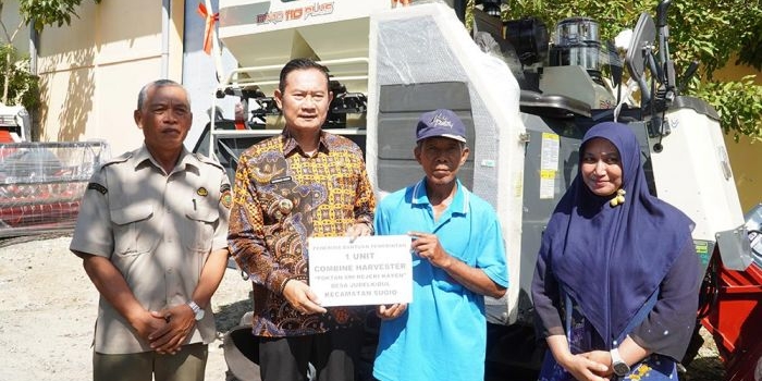 Bupati Yuhronur menyerahkan mesin combine harvester ke petani.