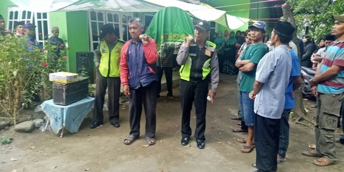 Jenazah saat diangkat petugas dibantu warga.