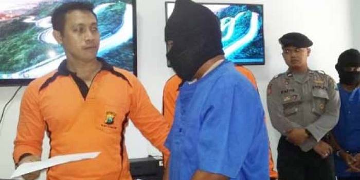 PASRAH. Pelaku inisial IS (biru) pasrah saat di cecar pertanyaan oleh Waka Polres Bojonegoro, Kompol Ikhwanudin (orange) di hadapan sejumlah awak media. Foto: Eky Nurhadi/BANGSAONLINE