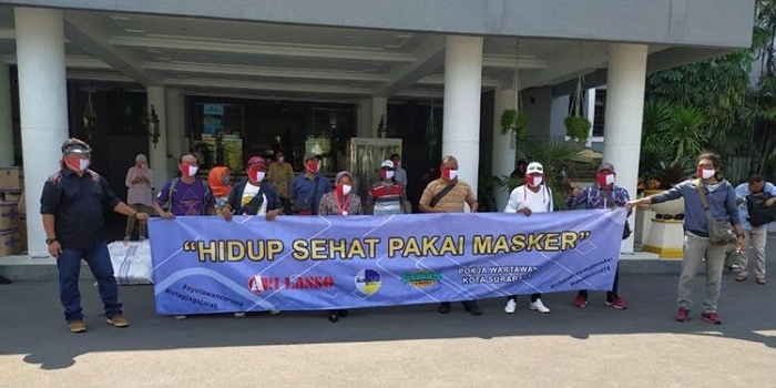 Dengan memakai masker merah putih, Wali Kota Risma foto bersama para awak media yang tergabung ke dalam Pokja Wartawan Pemkot Surabaya. (foto: YUDI A/ BANGSAONLINE).