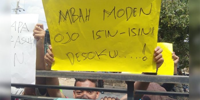 Aksi warga saat demo di depan Balai Desa Hargoretno sambil membawa sejumlah poster.