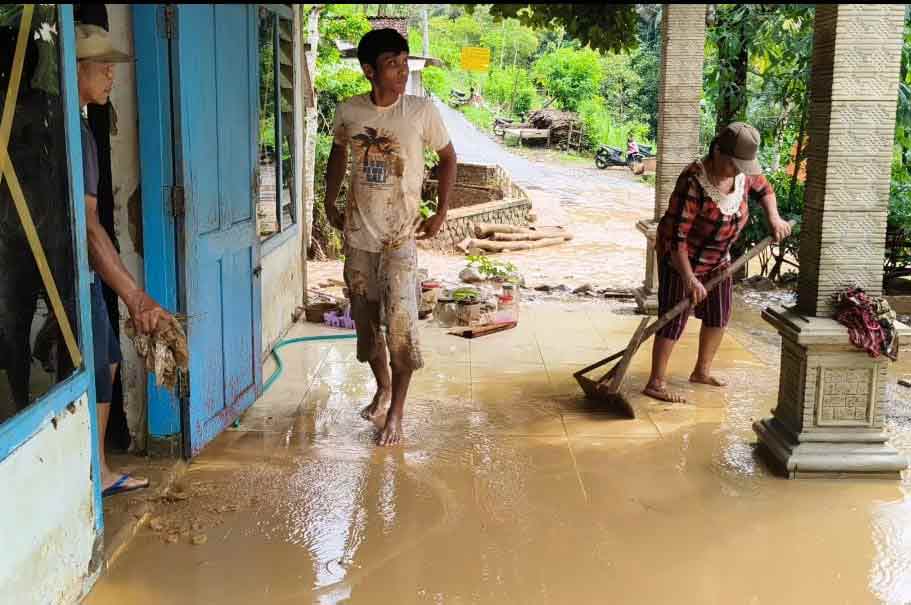 Warga saat membersihkan sisa banjir. Foto: Muji Harjita.