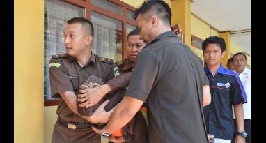Nenek Asyani digotong petugas sesaat setelah pingsan saat akan memasuki ruang sidang. foto: Hadi Prayitno/BangsaOnline.com