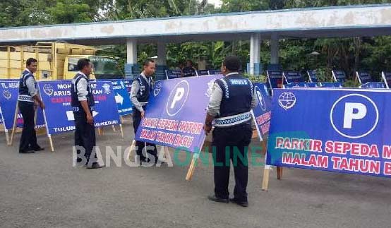 Petugas Dishub Kediri saat memasang papan pembatas untuk persiapan malam pergantian tahun di area simpang lima gumul (SLG). foto: arof kurniawan/ BANGSAONLINE