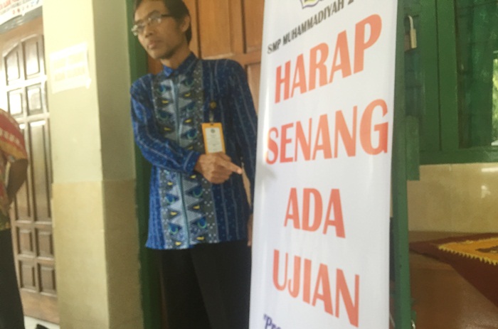 Kepala sekolah SMP Muhamadiyah 2 Kediri saat meninjau pelaksanaan ujian. Foto: ARIF KURNIAWAN/ BANGSAONLINE