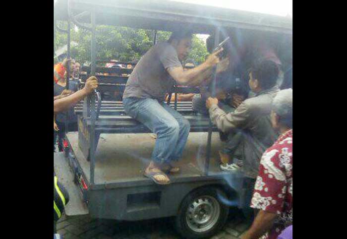 Petugas Polsek Cerme saat berusaha mengamankan pelaku dari amukan massa.