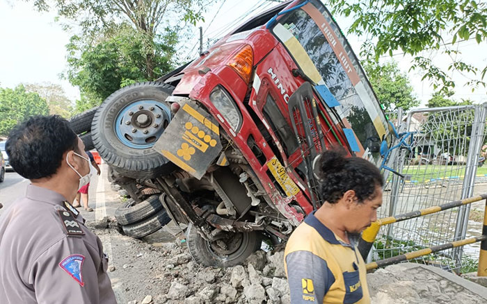 Petugas saat mengevakuasi truk trailer yang terguling di Jalan Raya Bakalan, Desa Wringinpitu, Kecamatan Balongbendo, Sidoarjo, Rabu (1/6/2022)