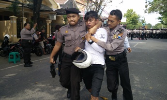 Salah seorang pendemo diamankan karena dianggap sebagai provokator bentrok antara polisi dan pendemo di Pamekasan. foto: rizal/BANGSAONLINE