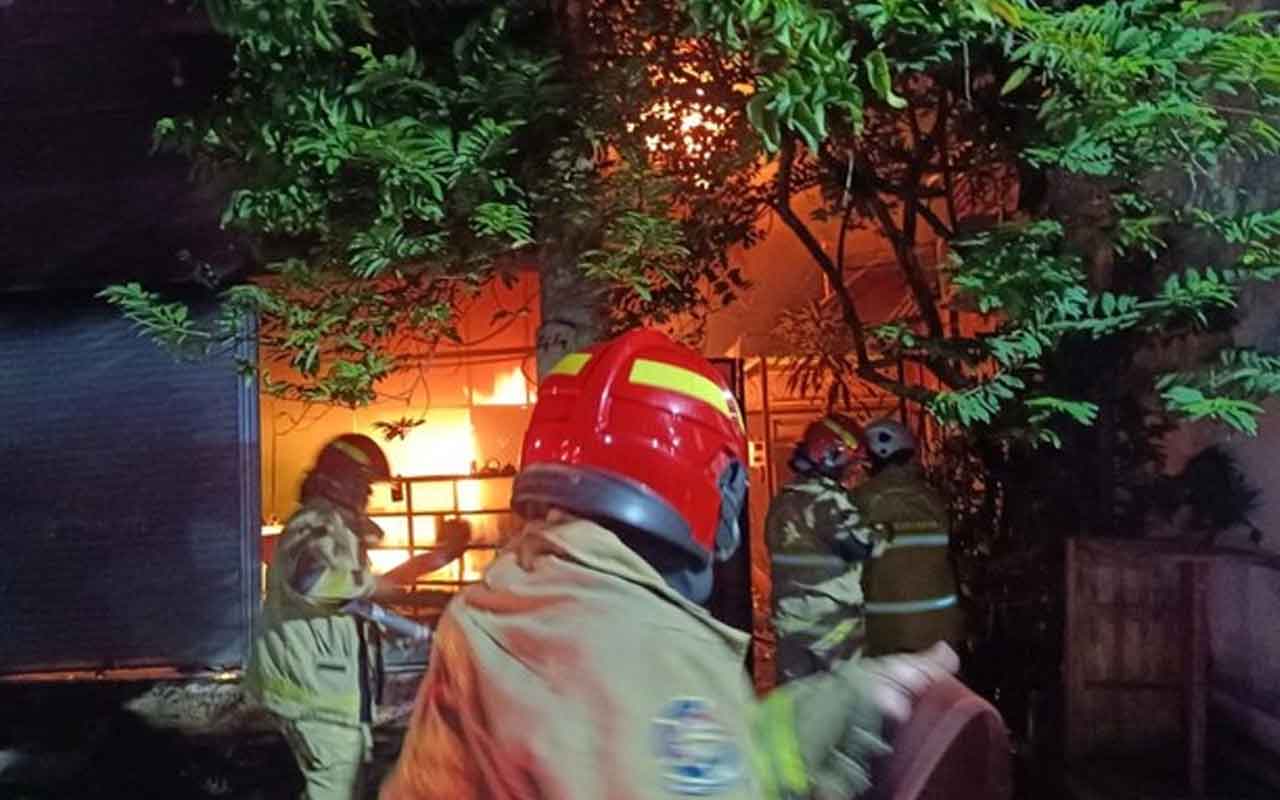 Petugas pemadam kebakaran saat proses pemadaman api di sebuah rumah di Jalan Simo Gunung I No 44, Kecamatan Sawahan, Surabaya. Foto: Ist.