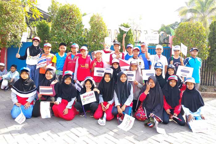 Siswa-siswi SDM 2 GKB berpenampilan layaknya kontingen negara peserta Asian Games saat menggelar pawai. foto: SYUHUD/ BANGSAONLINE