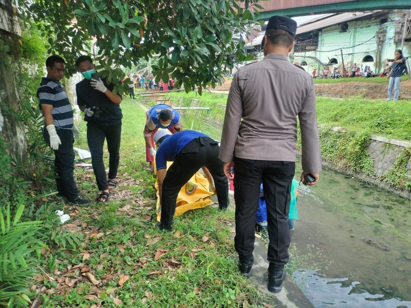 Petugas saat mengevakuasi mayat pria yang ditemukan di sungai sebelah PG Candi