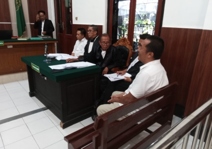Terdakwa (baju putih, kanan) saat menjalani persidangan di PN Surabaya