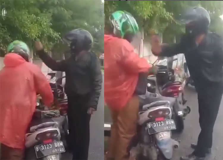 Tangkapan layar seorang pria berjaket hitam yang diduga seorang oknum polisi memukul kepala driver ojek online saat berhenti di pinggir jalan.