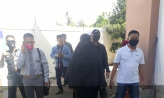 Dengan memakai cadar, penggugat dikawal anggota LSM GMBI.