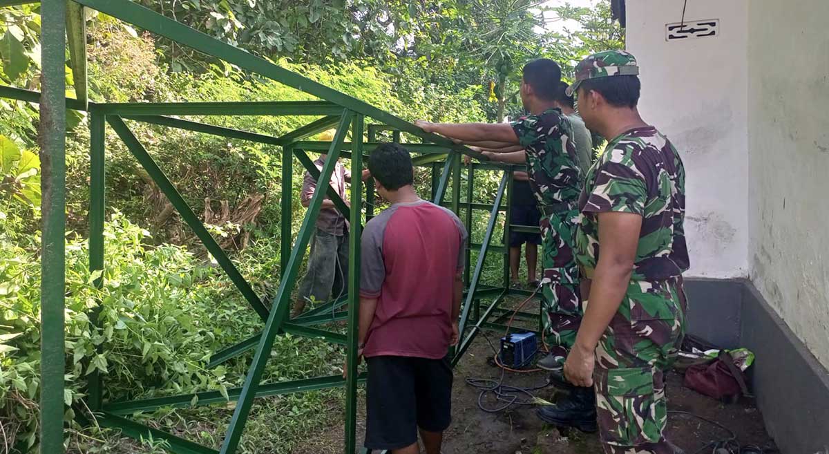 Warga Dusun Buluh Bebe bersama prajurit Kodim 0829/Bangkalan ketika mengangkat kerangka tandon.
