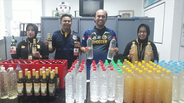 Danny Yudi Satriawan menunjukkan botol miras yang berhasil disita.