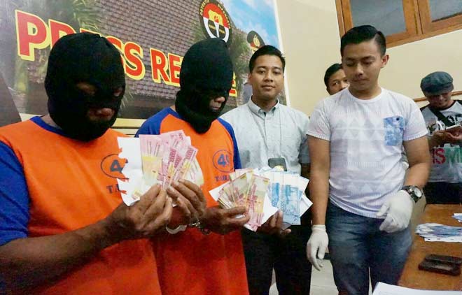 Kasatreskrim Polres Jombang, AKP Herio Romadhona Chaniago saat menunjukkan barang bukti dan pelaku penyebaran Upal, Kamis (16/6). foto: ROMZA/ BANGSAONLINE