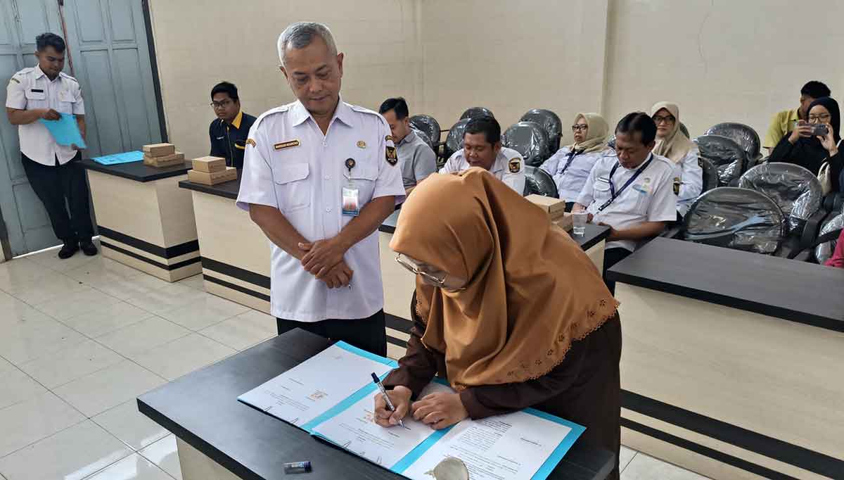 Kepala Dispendukcapil Kota Kediri, Marsudi Nugroho, saat melakukan penandatanganan perjanjian kerja sama dengan salah satu pemilik toko. Foto: Ist