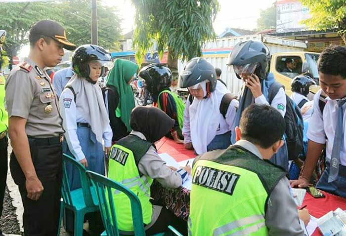 Satlantas Polres Blitar memberikan sanksi tilang kepada pelajar yang tidak memiliki kelengkapan berkendara.
