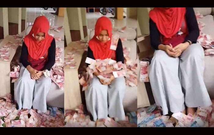 Nila Rahmaniar menunduk saat dilempari uang oleh Ovie. Gambar yang berasal dari video ini kini viral di media sosial. 