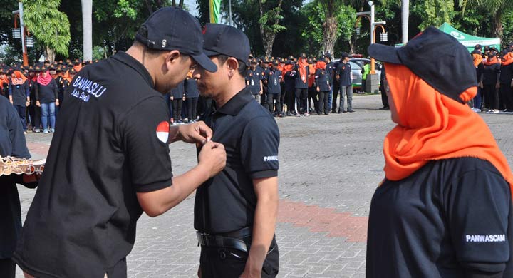 Ketua Bawaslu Imron Rosyadi menyematkan pin kepada petugas pengawas pemilu. 