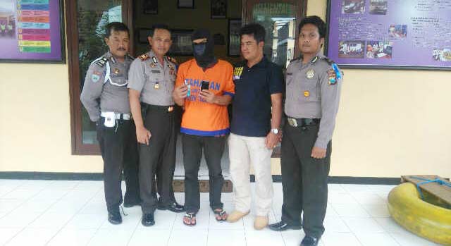 Tersangka diapit petugas dari Polsek Tulangan. foto: catur 