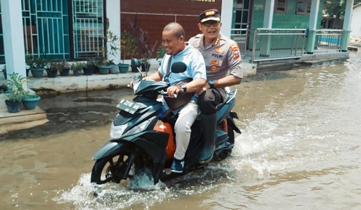 Kapolresta Sidoarjo yang baru, Kombes Pol Sumardji, turun melakukan peninjauan ke wilayah terdampak banjir di Tanggulangin dibonceng wartawan BANGSAONLINE.com Catur 