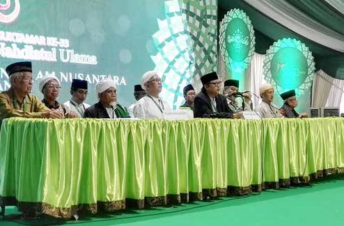 Gus Mus didampingi pimpinan sidang saat mengeluarkan fatwa pemilihan Rais Aam akan ditentukan secara musyawarah mufakat oleh Rais Suriah se-Indonesia. (foto: merdeka)