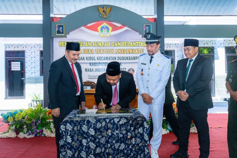 Bupati Gresik Fandi Akhmad Yani (dua dari kiri) menandatangani prasasti usai melantik Kades Wadak Kidul PAW Ashifur Rohib. Foto: Ist.