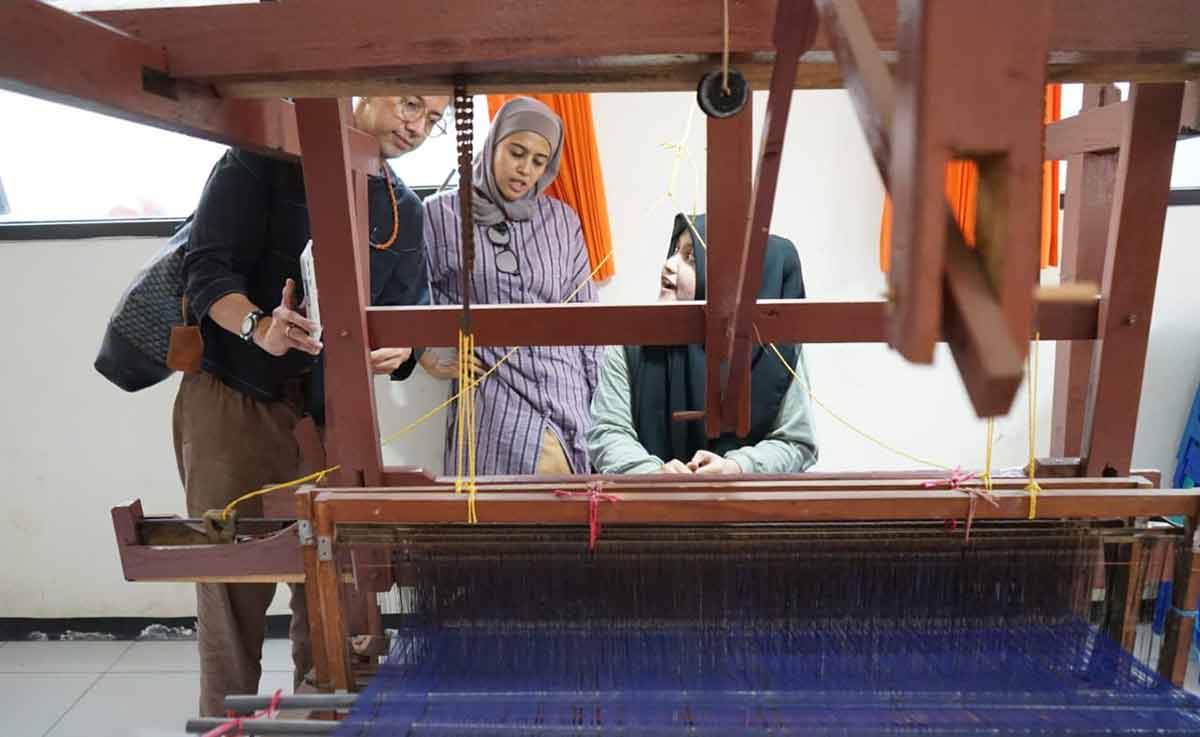 Ketua Dekranasda Kota Kediri, Ferry Silviana Abu Bakar (tengah), dan desainer nasional Didiet Maulana saat melihat dari dekat proses membuat tenun. Foto: Ist