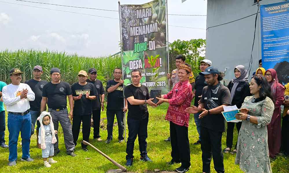 Yuwono (kanan), seorang penggiat herbal dan lingkungan di Kediri secara simbolis menyerahkan bibit pohon Joho kepada Kepala Desa Joho, Setyo Wibowo untuk ditanam bersama-sama. Foto: Muji Harjita/Bangsaonline.