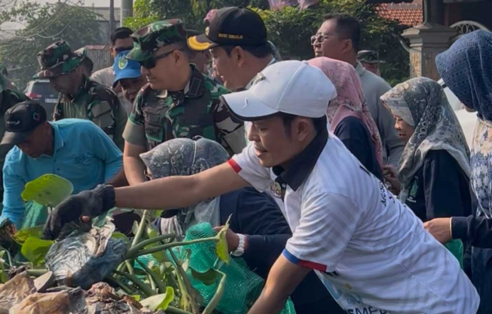 Dedi Irwansa ikut membersihkan sampah di Kali Pelayaran, Desa Krembangan Taman, Sabtu (21/6/2025). Foto: Ist.