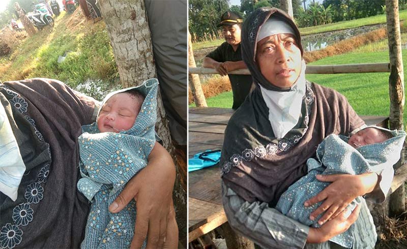 Salah satu warga menggendong bayi yang ditemukan di sebuah gubuk.