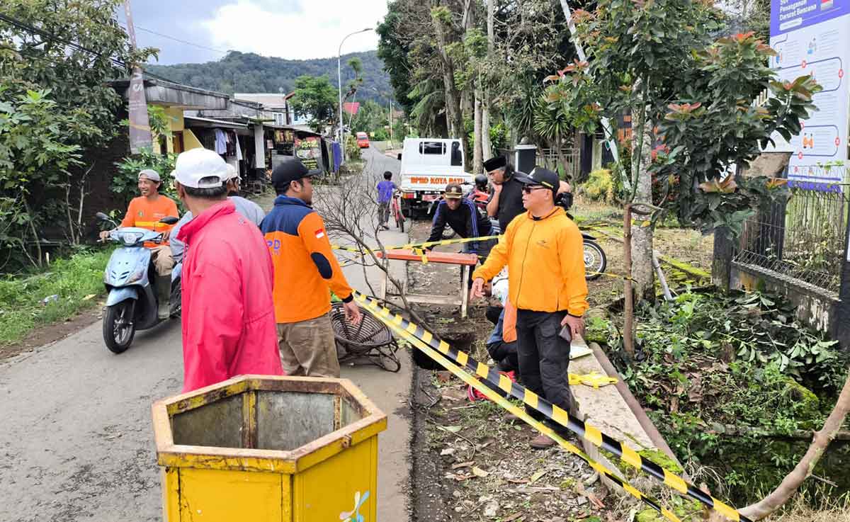 Petugas saat meninjau dampak longsor di Kota Batu.