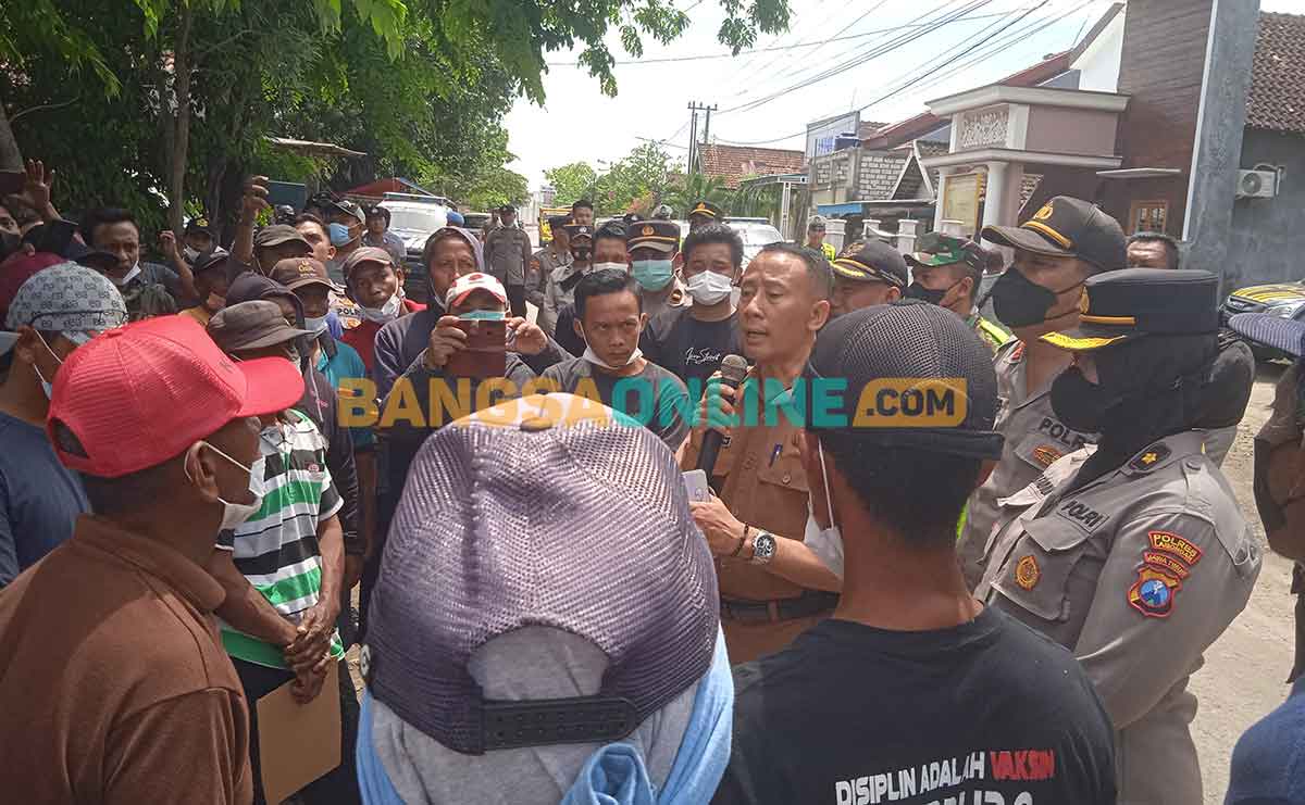 Camat Tikung, Arifin, saat menemui massa aksi. Foto: NUR QOMAR HADI/BANGSAONLINE