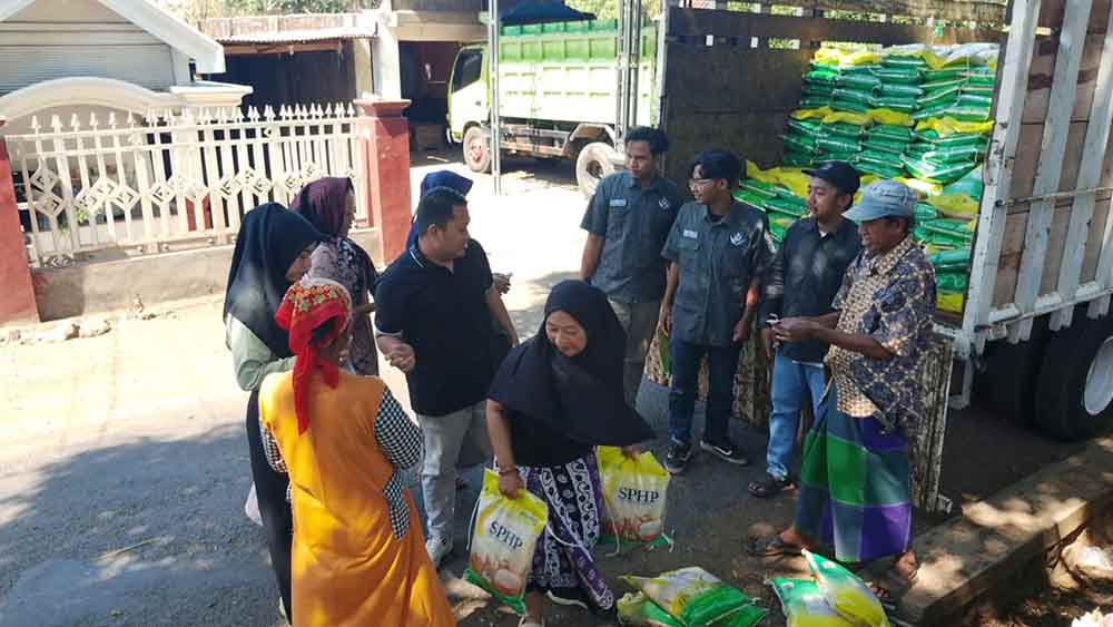 Mahasiswa BEM Pasuruan Raya bersama jajaran Polres Pasuruan saat mendistribusikan beras murah ke warga desa.