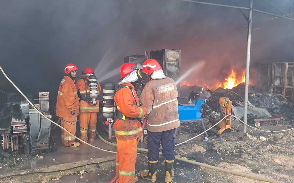 Petugas Damkar berjibaku memadamkan kobaran api  di gudang material komplek PT Hailiang. Foto: Ist.