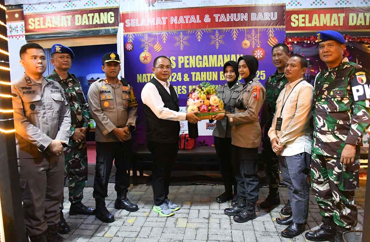 Pj Wali Kota Madiun saat memberikan cendera mata kepada petugas di pos pengamanan.