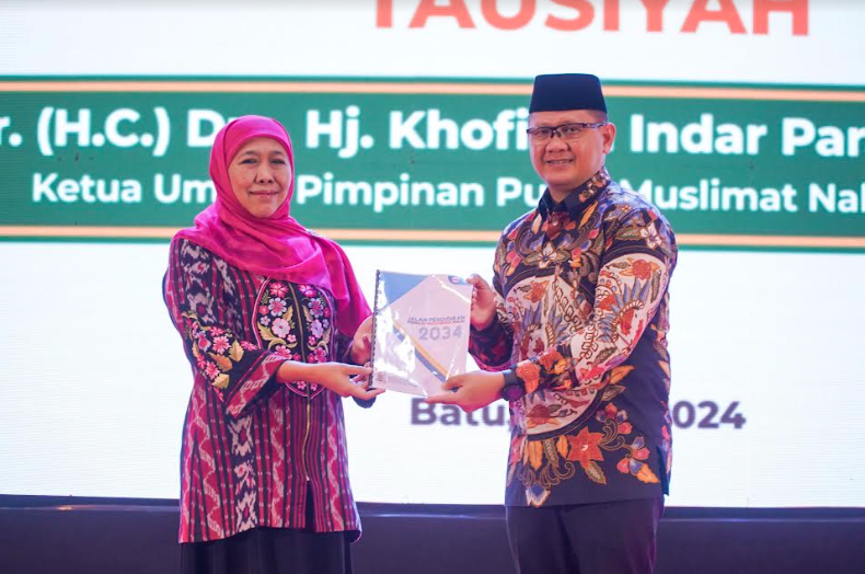 Khofifah saat menyerahkan buku konsep secara simbolis pada Kepala Dinas Pendidikan Jawa Timur Aries Agung Paewai (dok. Ist)