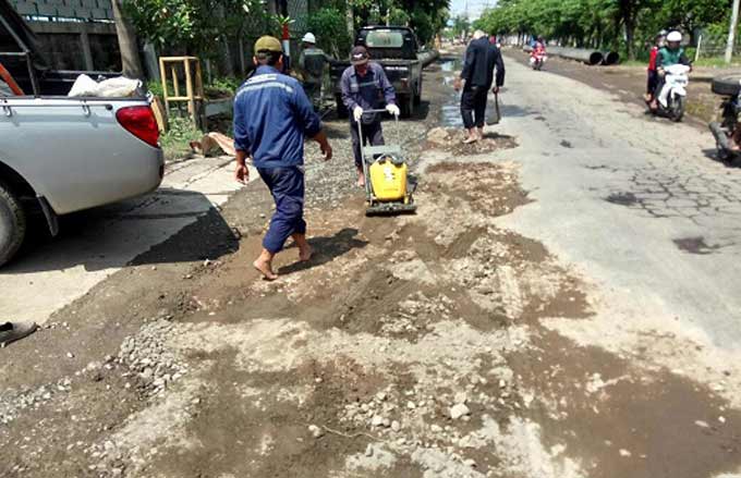 URC Bima DPUTR Gresik ketika melakukan tambal sulam Jalan Mayjen Sungkono, Kebomas. foto: Syuhud/ bangsaonline.com
