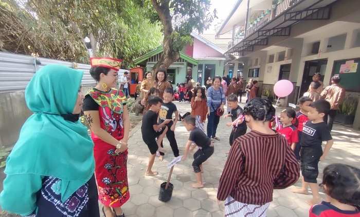 Wakil Kepala SD Emaus Bidang Kurikulum Ana Ribudi Ningsih (berpakaian adat) bersama Eri (berjilbab) dari Kementerian Pendidikan saat melihat anak-anak yang sedang bermain lompat tali. Foto: MUJI HARJITA/ BANGSAONLINE.com