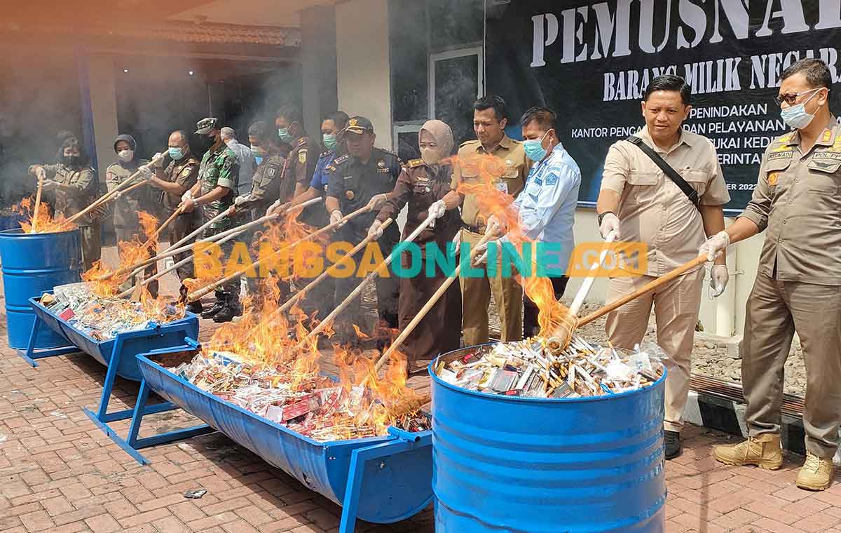 Kepala Kantor Bea dan Cukai Kediri, Sunaryo, dan para undangan secara simbolis saat melakukan pembakaran barang bukti. Foto: MUJI HARJITA/BANGSAONLINE